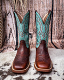 Turquoise and brown cowboy boots on a textured surface
