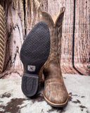 Brown cowboy boots on a textured surface