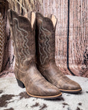 Brown cowboy boots on a textured surface