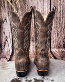 Brown cowboy boots on a textured surface