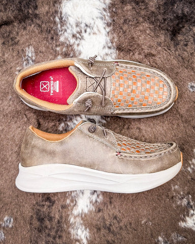Pair of brown leather shoes with white soles on a textured brown background