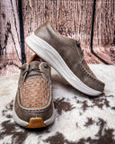 Pair of brown casual shoes with woven pattern on a textured surface