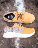 Twisted X Feather X sneaker on a textured background