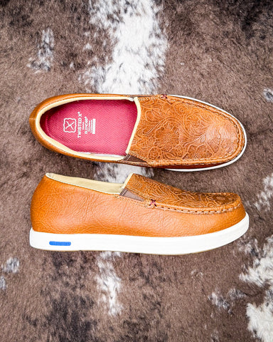 Pair of brown loafers on a textured surface