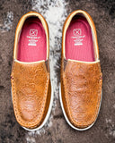 Pair of brown loafers on a textured surface