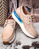 Pair of beige shoes with a blue sole accent on a textured surface
