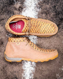 Pair of brown leather shoes with textured pattern on a textured surface