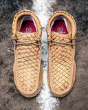 Pair of brown leather shoes with textured pattern on a textured surface