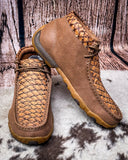 Pair of brown leather shoes with textured pattern on a wooden surface