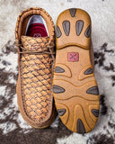 Pair of brown leather shoes with textured pattern on a textured surface