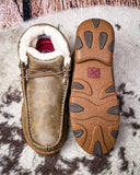 Brown slip-on shoe with fur lining on a textured surface