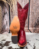 Red cowboy boot with 'Black Star' branding on a wooden background