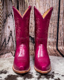 Western Boots on Cowhide rug brown board in background 