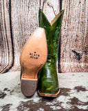 Green cowboy boot with 'Black Star' branding on a wooden background