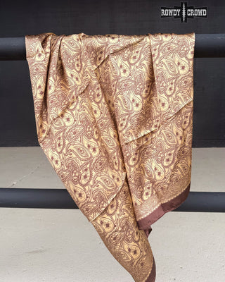 Brown patterned fabric draped over a black bar with 'Rowdy Crow' branding.