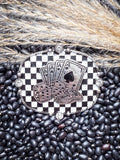 Silver buckle with casino theme on checkerboard, styled on beans and wheat.