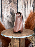 Side profile of leather western purse showing D-ring and brown leather gusset