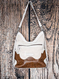 Back view of western hobo bag with ivory suede, floral tooled leather, and zippered pocket