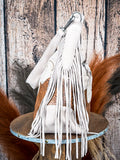 Side view of ivory suede fringe handbag with embossed leather panel and shoulder strap