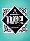Zoomed-in view of Bronco Western Supply Co. back graphic on bright teal tee