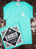 Bright teal Bronco tee with chest logo and folded view showing bold back graphic