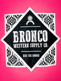 Detailed view of Bronco Western Supply Co. back graphic on neon pink tee