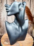 Western oval stud earring with silver scroll tooling and rope trim shown on display mannequin
