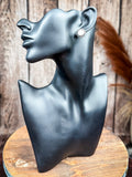 Classic round silver stud earring with twisted rope edge displayed on black mannequin bust
