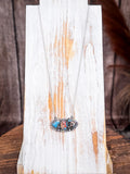 Rustic western three-stone necklace with turquoise and jasper on distressed white wood display