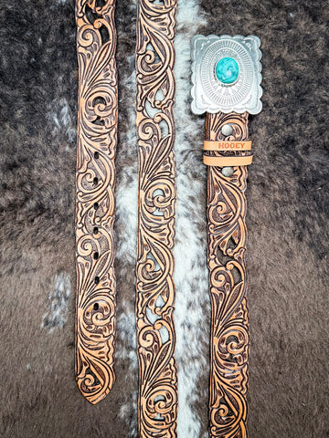 Hooey Rogue belt on a cowhide background