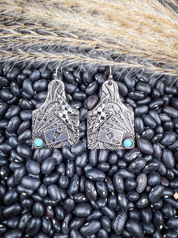 Earrings displayed on beans and wheat