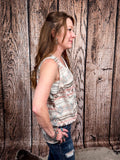 Model wearing tank top standing in front of a wood background.