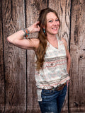 Model wearing tank top standing in front of a wood background.