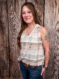 Model wearing tank top standing in front of a wood background.