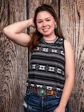 Model wearing tank top standing in front of a wood background.