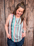 Model looking down in front of a wood background wearing the Sunstripe Serape Tank Top.