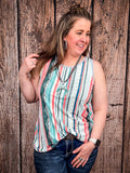 Model playing with their hair in front of a wood background wearing the Sunstripe Serape Tank Top.