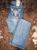Flat lay of folded jeans on cowhide. 