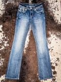 Front view flat lay of jeans laying out on cowhide.