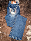Flat lay of jeans folded on cowhide.