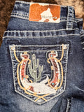 Close up of embellished back pockets on jeans.