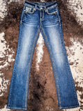 Flat lay front view of jeans laying out on cowhide.