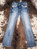 Flat lay showing off the front view of the jeans laid out on cowhide.