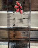 stud earring on ruler
