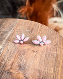 stud earrings on wood table