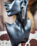 earrings on mannequin