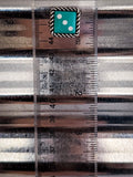 blue dice earring on ruler