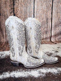 boots on cowhide, wood backdrop