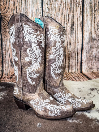 boots on cowhide, wood backdrop