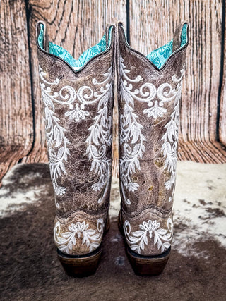 back of boots on cow hide, wood backdrop
